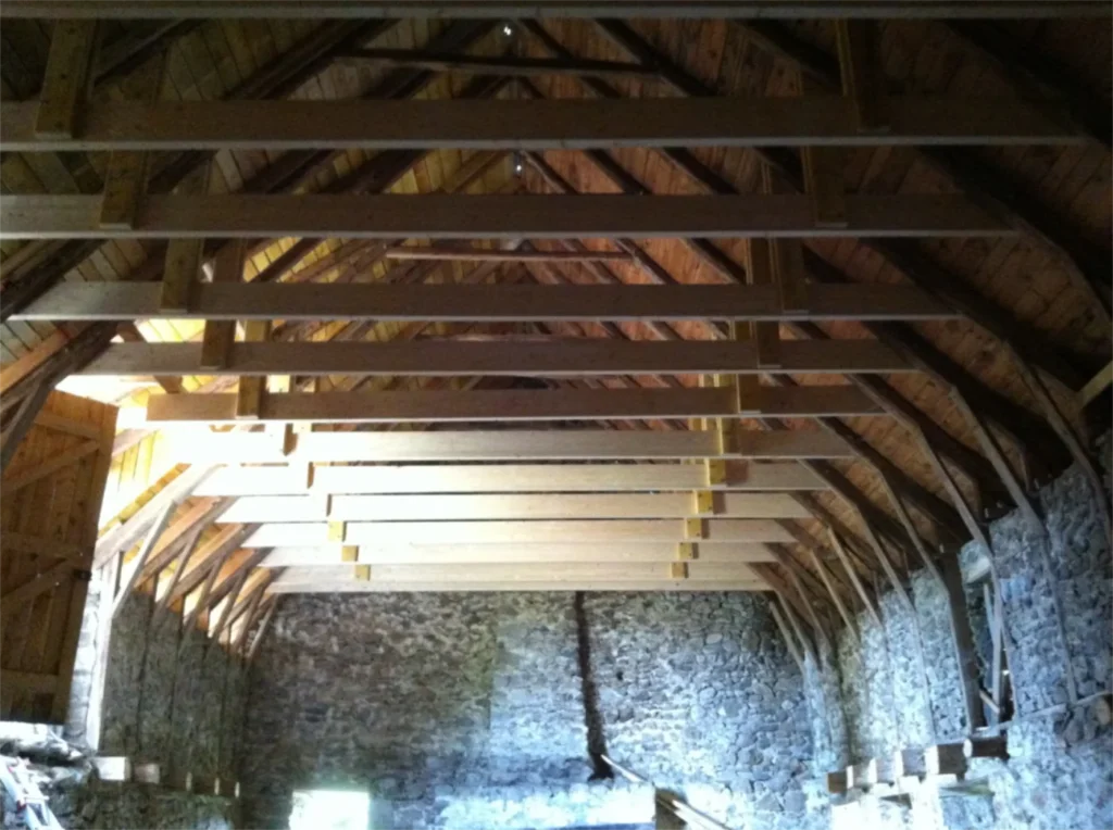 The inside of La Grange during the works: the timber frame under the roof